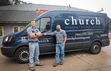 Two HVAC leaning up on a blue church plumbing van.