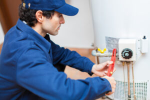 Plumber fixing a hot-water heater