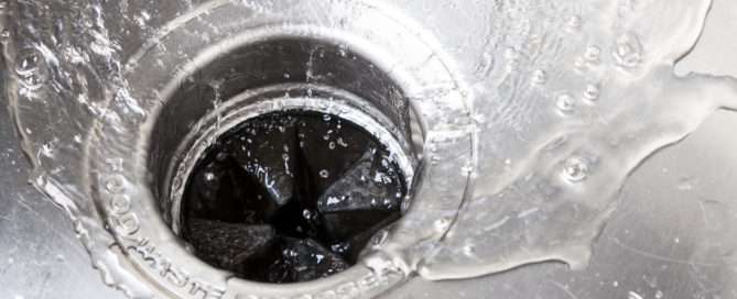 wide shot of garbage disposal with water flowing down it